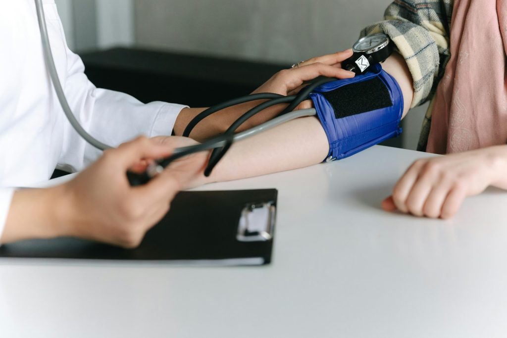 Photo of a healthcare worker checking a child's blood pressure.