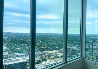 Installed soundproof window inserts in a highrise apartment, overlooking a city.